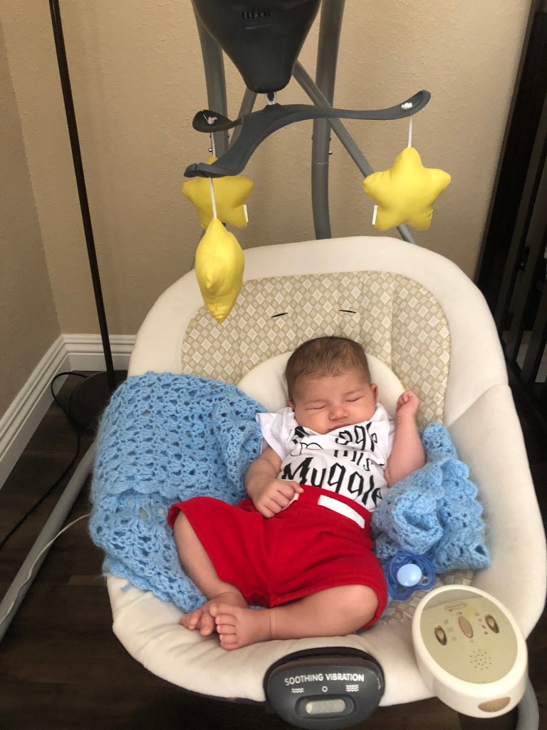 Baby in swing first week of parenthood