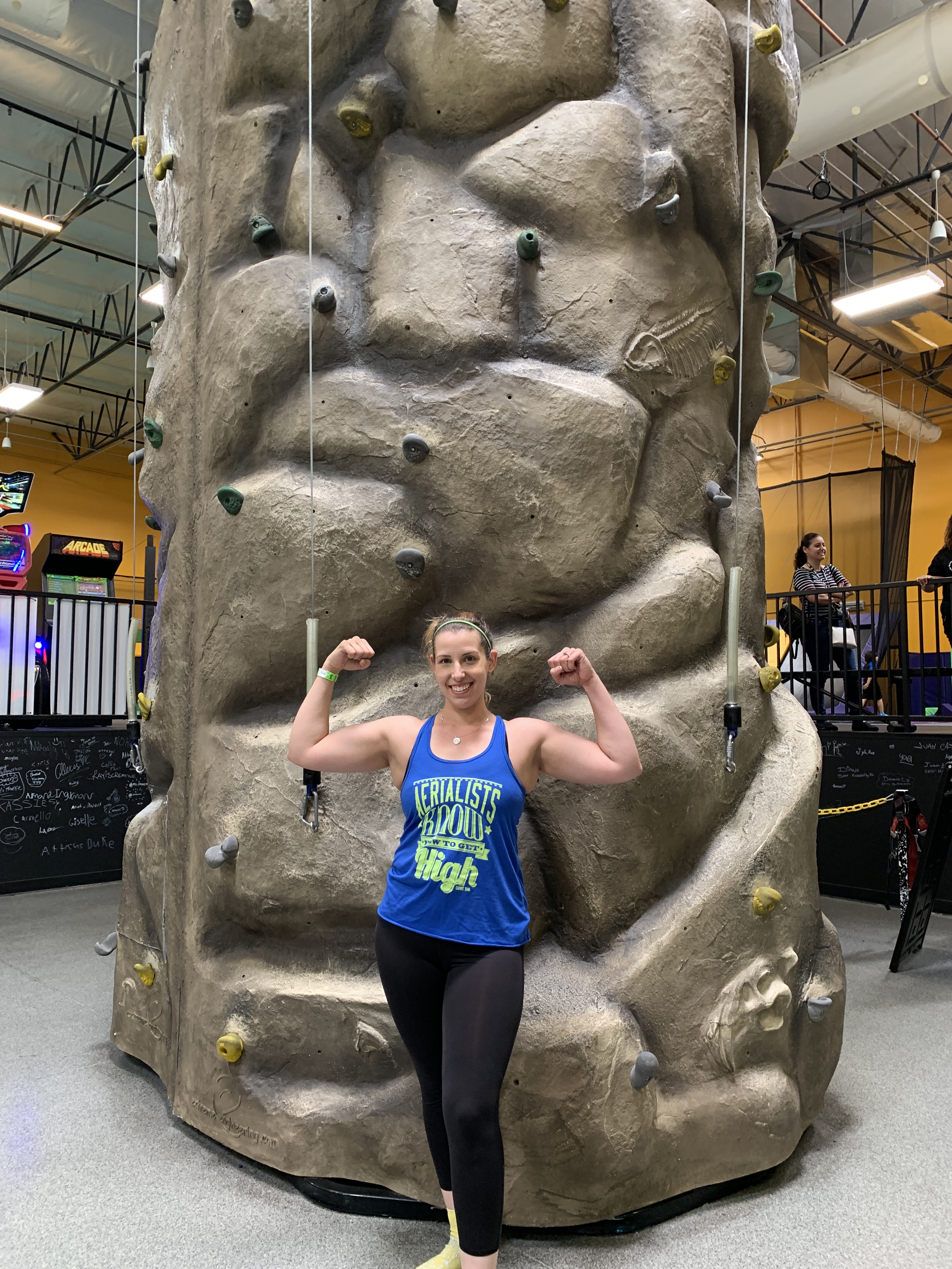 woman in front of rock climbing wall